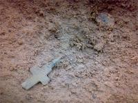 Крестик лежит,как был,монетку шевельнул,чтобы была видна лучше.Предметы лежат в 20 сантиметрах от следа 